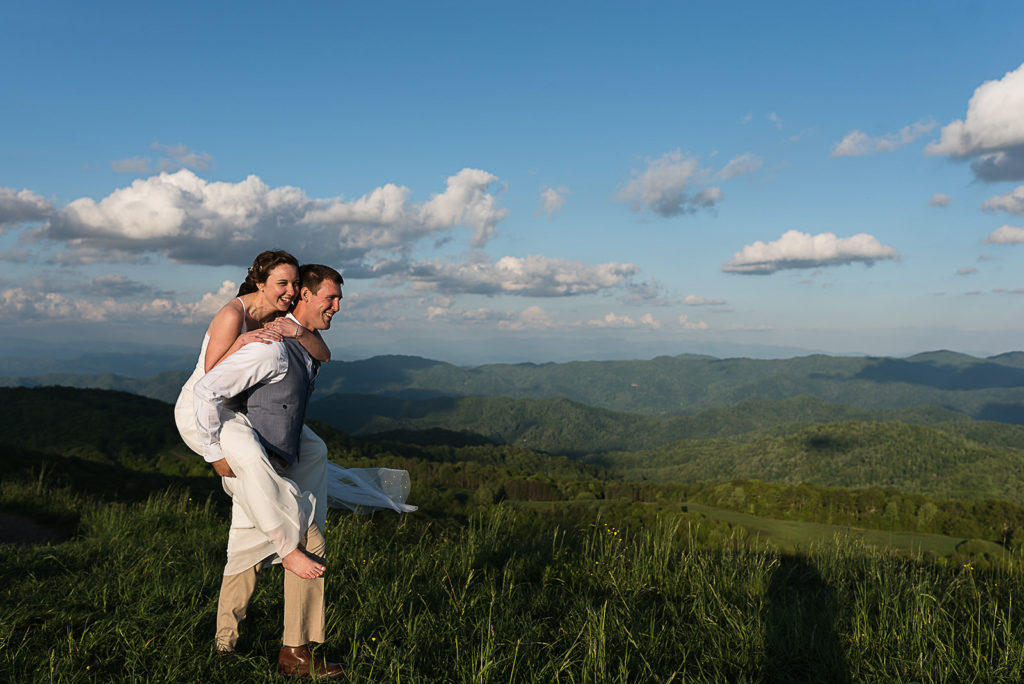 The bride rides piggy back at max patch after eloping.