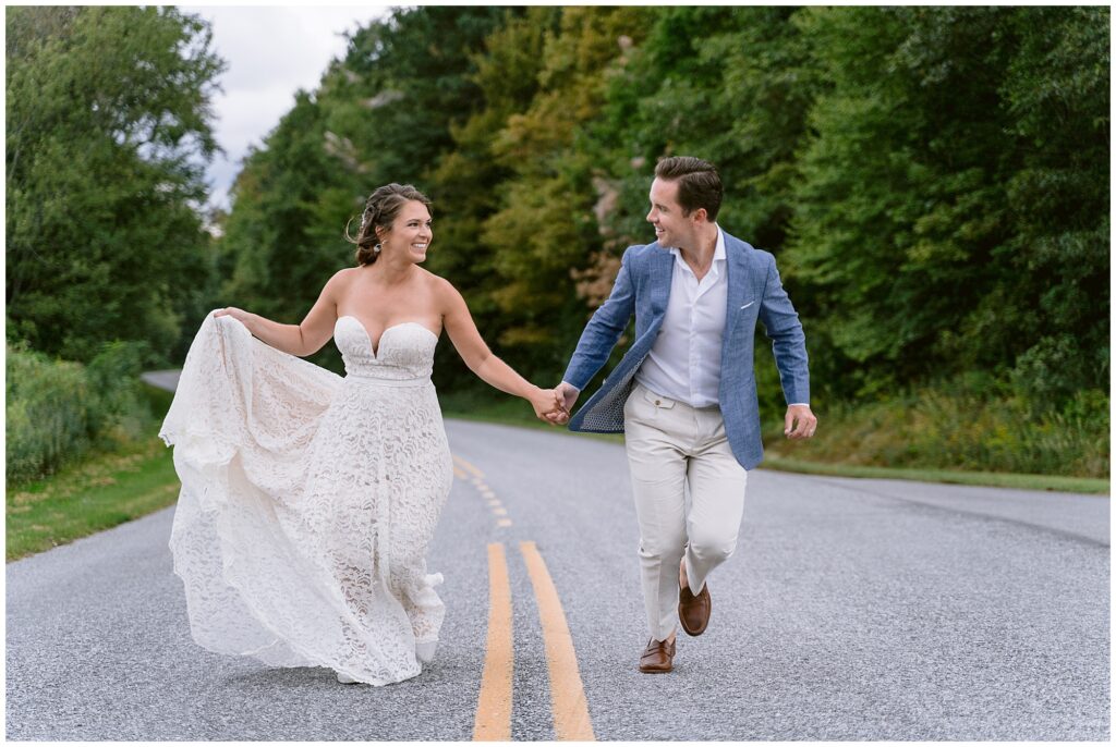 Bride and groom running up the street together after their vow exchange in the blue ridge mountains.