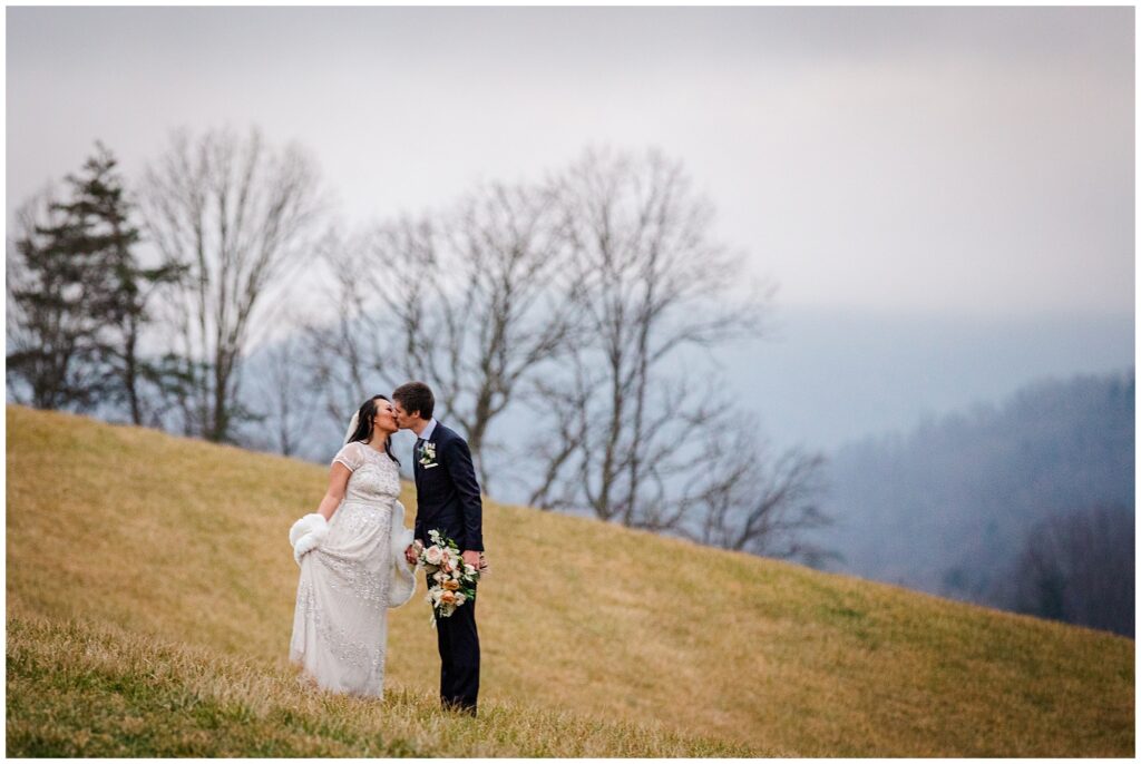 bride and groom share a kiss in the mountains at their elopement venue