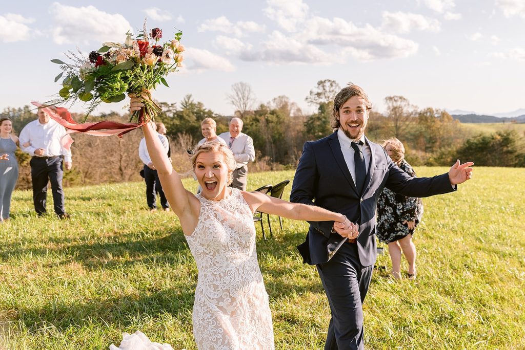 Bride and groom cheer after eloping in the mountains at an Airbnb.